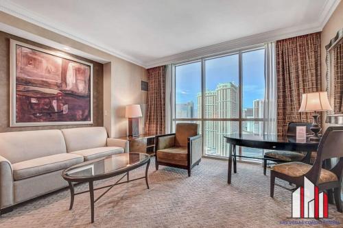 a living room with a couch and a table at MGM Signature-21-609 Strip View Jacuzzi Studio in Las Vegas