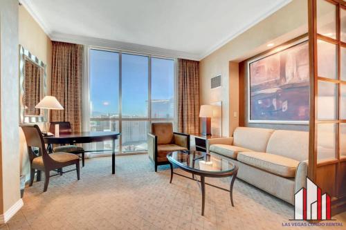 a living room with a couch and a table at MGM Signature-36-603 Strip View Jacuzzi Studio in Las Vegas