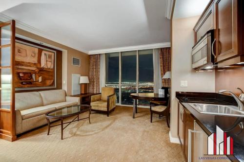 a living room with a couch and a table at MGM Signature-28-816 Jacuzzi Studio in Las Vegas