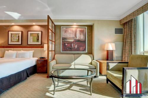a hotel room with a bed and a glass table at MGM Signature-02-604 Jacuzzi Studio in Las Vegas