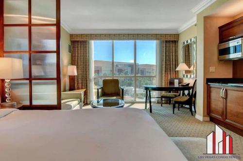 a hotel room with a large bed and a desk at MGM Signature-02-604 Jacuzzi Studio in Las Vegas