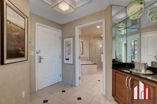 a bathroom with a sink and a white door at MGM Signature-02-604 Jacuzzi Studio in Las Vegas