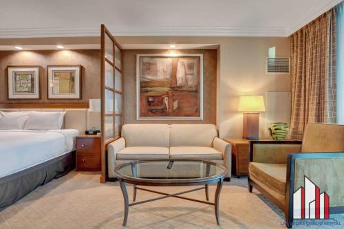 a hotel room with a bed and a coffee table at MGM Signature-04-704 Jacuzzi Studio in Las Vegas