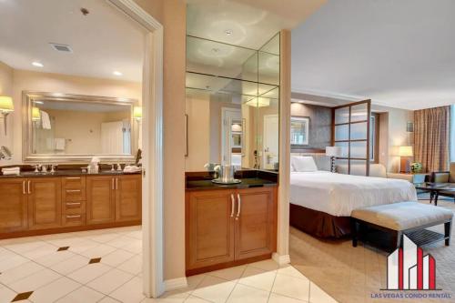 a bedroom with a bed and a bathroom with a sink at MGM Signature-04-704 Jacuzzi Studio in Las Vegas