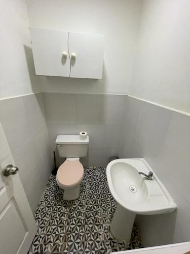 a small bathroom with a toilet and a sink at Illa B&B in Cusco