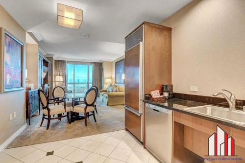 a kitchen and dining room with a table and chairs at MGM Signature-10-714 1Br Balcony Suite Accessible in Las Vegas