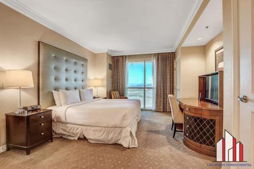 a hotel room with a bed and a desk and a television at Signature 2Br3Ba balcony combo units 28-602 and 04 in Las Vegas