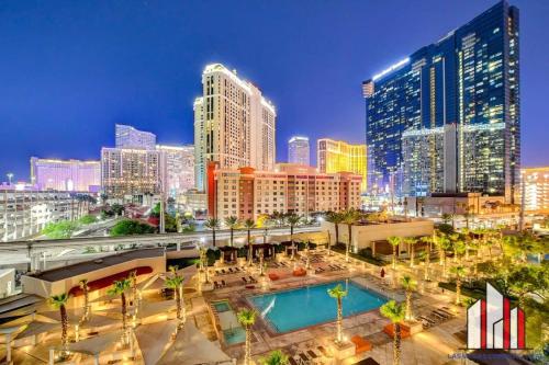 a city skyline with tall buildings and a pool at MGM Signature-04-707 Strip View Balcony Studio in Las Vegas