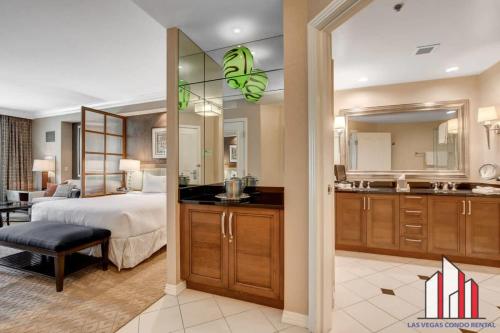 a bedroom with a bed and a large mirror at MGM Signature-04-707 Strip View Balcony Studio in Las Vegas