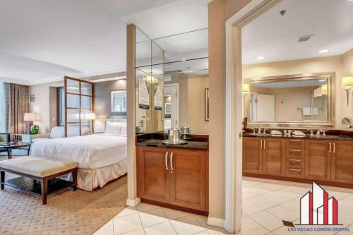 a large bedroom with a bed and a bathroom at MGM Signature-17-703 Strip View Jacuzzi Studio in Las Vegas