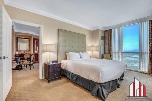 a hotel room with a bed and a large window at MGM Signature-25-702 1Bedroom 2Bath Balcony Suite in Las Vegas