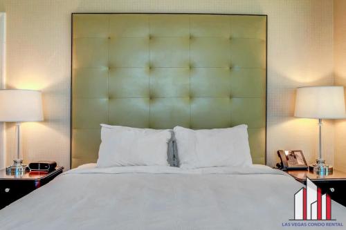 a bedroom with a large white bed with two lamps at MGM Signature-25-702 1Bedroom 2Bath Balcony Suite in Las Vegas