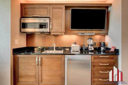 a kitchen with a sink and a microwave at MGM Signature-16-704 Jacuzzi Studio in Las Vegas