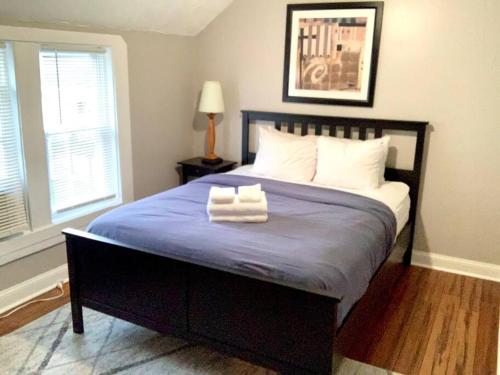 a bedroom with a bed with two towels on it at The House Hotels - W45th Backhouse - Ohio City District Home - 5 Minutes from Downtown in Cleveland