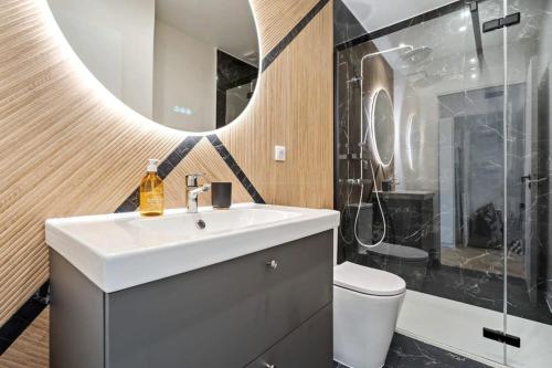 a bathroom with a sink and a toilet and a mirror at Tranquil Retreat in the Vianden ID224 in Luxembourg