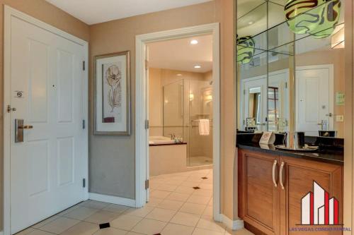 a large bathroom with a sink and a mirror at MGM Signature-24-709 Strip View Jacuzzi Studio in Las Vegas