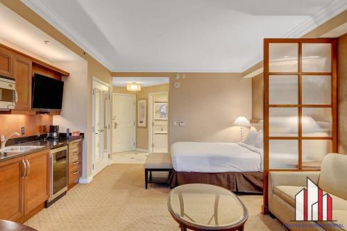 a hotel room with a bed and a kitchen at MGM Signature-09-718 Jacuzzi Studio in Las Vegas