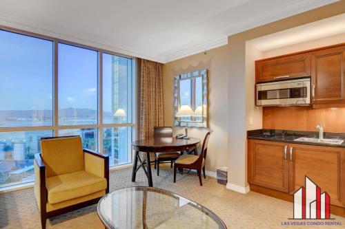 a living room with a kitchen and a table and a dining room at MGM Signature-09-718 Jacuzzi Studio in Las Vegas