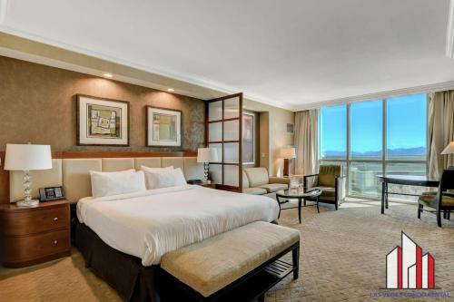 a hotel room with a large bed and a desk at MGM Signature-08-604 Jacuzzi Studio in Las Vegas