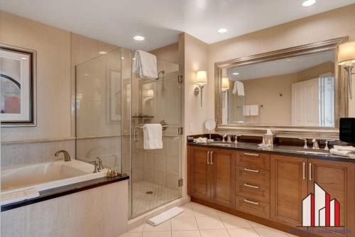 a bathroom with a tub and a sink and a shower at MGM Signature-08-604 Jacuzzi Studio in Las Vegas