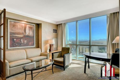 a living room with a couch and a table at MGM Signature-08-604 Jacuzzi Studio in Las Vegas