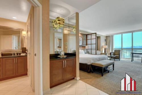 a bedroom with a bed and a bathroom with a kitchen at MGM Signature-08-604 Jacuzzi Studio in Las Vegas