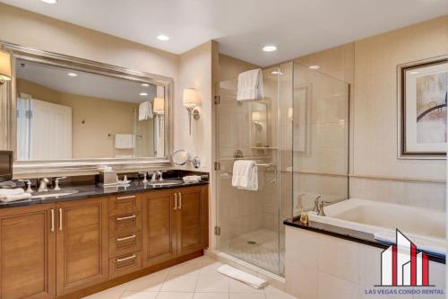 a bathroom with a tub and a sink and a shower at MGM Signature-17-718 Jacuzzi Studio in Las Vegas