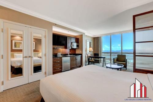a hotel room with a large bed and a kitchen at MGM Signature-17-718 Jacuzzi Studio in Las Vegas