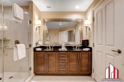 a bathroom with a sink and a mirror and a shower at MGM Signature-17-718 Jacuzzi Studio in Las Vegas