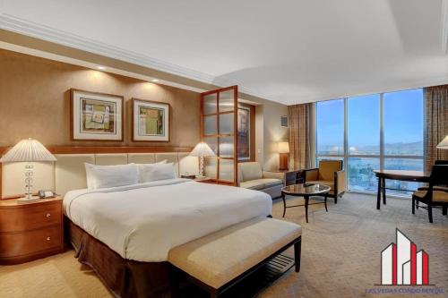 a hotel room with a large bed and a desk at MGM Signature-09-716 Jacuzzi Studio in Las Vegas