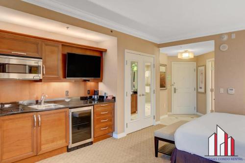 a bedroom with a bed and a kitchen with a sink at MGM Signature-09-716 Jacuzzi Studio in Las Vegas