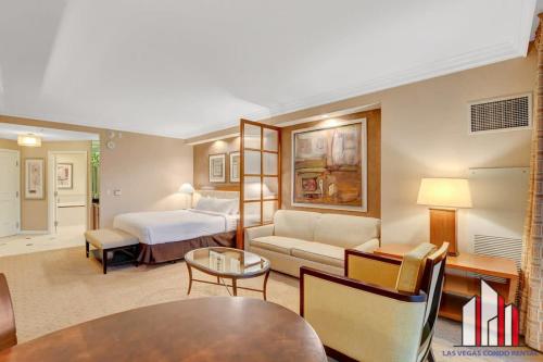 a hotel room with a bed and a couch at MGM Signature-09-716 Jacuzzi Studio in Las Vegas