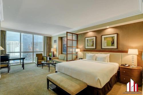 a hotel room with a large bed and a desk at MGM Signature-22-611 Strip View Jacuzzi Studio in Las Vegas