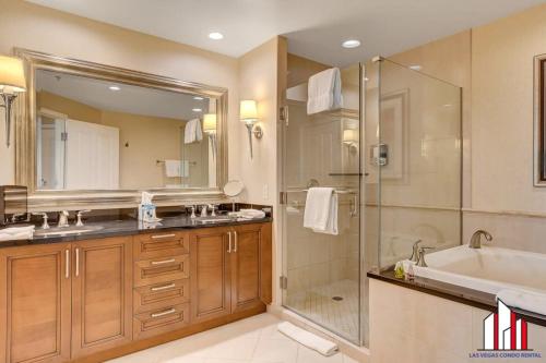a bathroom with a tub and a sink and a shower at MGM Signature-22-611 Strip View Jacuzzi Studio in Las Vegas