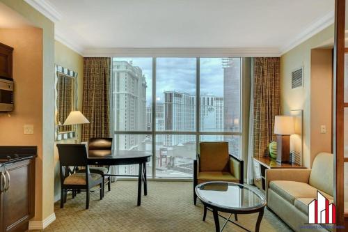 a living room with a view of a city at MGM Signature-22-611 Strip View Jacuzzi Studio in Las Vegas