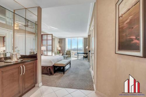 a hotel room with a bed and a bathroom at MGM Signature-15-604 Jacuzzi Studio in Las Vegas