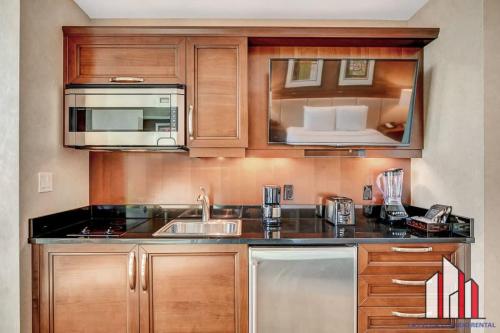 a kitchen with a sink and a microwave at MGM Signature-15-604 Jacuzzi Studio in Las Vegas