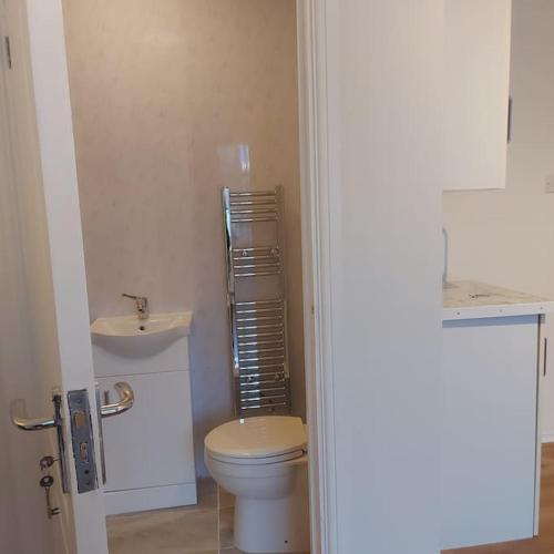 a bathroom with a toilet and a sink at Jemima Place semi-detached hse. in Wallington