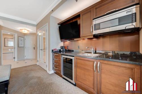 a kitchen with a sink and a microwave at MGM Signature-15-611 Strip View Jacuzzi Studio in Las Vegas