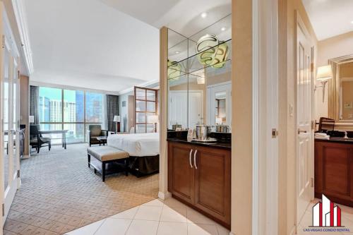 a hotel room with a bed and a bathroom at MGM Signature-15-611 Strip View Jacuzzi Studio in Las Vegas