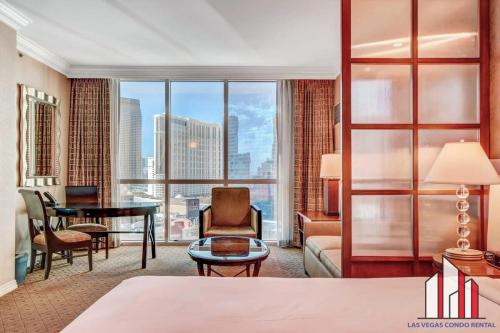 a hotel room with a bed and a large window at MGM Signature-15-611 Strip View Jacuzzi Studio in Las Vegas