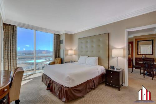 a large hotel room with a bed and a desk and a desk at MGM Signature-20-608 1Br 2Ba Balcony Jacuzzi Suite in Las Vegas