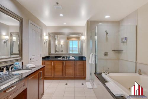a bathroom with a tub and a shower and a sink at MGM Signature-20-608 1Br 2Ba Balcony Jacuzzi Suite in Las Vegas