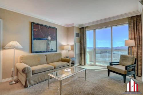 a living room with a couch and a chair at MGM Signature-20-608 1Br 2Ba Balcony Jacuzzi Suite in Las Vegas