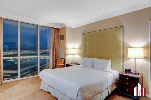 a hotel room with a large bed and a large window at MGM Signature-20-620 1Br 2Ba Balcony Suite in Las Vegas