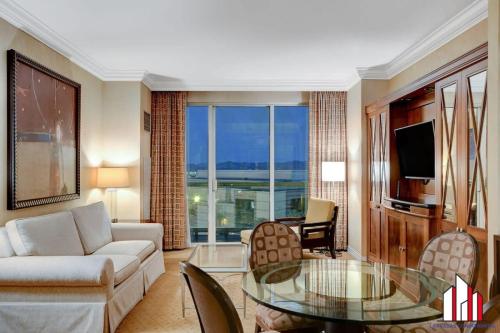 a living room with a couch and a glass table at MGM Signature-07-620 1Br 2Ba Balcony Suite in Las Vegas