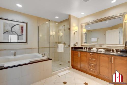 a bathroom with a tub and a sink and a shower at MGM Signature-24-716 Jacuzzi Studio in Las Vegas