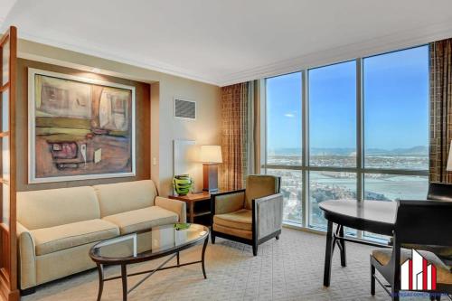 a living room with a couch and a table at MGM Signature-24-716 Jacuzzi Studio in Las Vegas