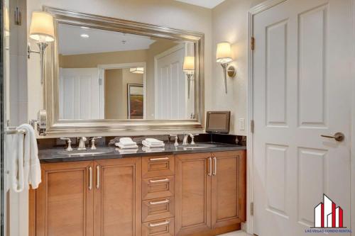 a bathroom with a sink and a large mirror at MGM Signature-24-716 Jacuzzi Studio in Las Vegas
