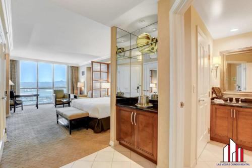 a hotel room with a bed and a bathroom at MGM Signature-24-606 Jacuzzi Studio in Las Vegas